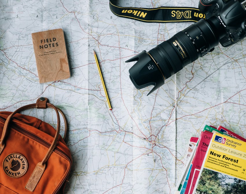 Travel planning with a map and travel essentials